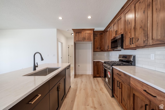 335 E Ventura Blvd, Stansbury Park, UT 84074 - kitchen featuring appliances with stainless steel finishes, light wood-style flooring, recessed lighting, backsplash, and brown cabinetry