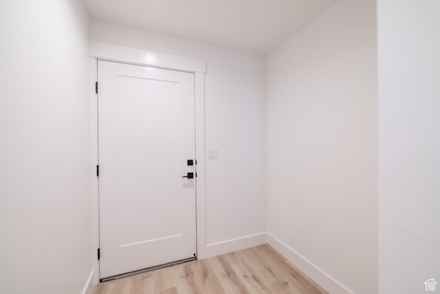 335 E Ventura Blvd, Stansbury Park, UT 84074 - doorway to outside featuring light wood-type flooring and baseboards