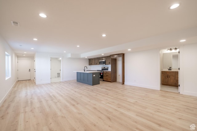 335 E Ventura Blvd, Stansbury Park, UT 84074 - unfurnished living room featuring light wood-style floors and recessed lighting