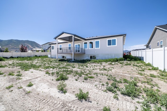 335 E Ventura Blvd, Stansbury Park, UT 84074 - rear view of property with a mountain view and a balcony