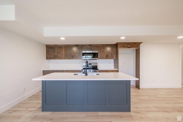 335 E Ventura Blvd, Stansbury Park, UT 84074 - kitchen featuring appliances with stainless steel finishes, recessed lighting, light countertops, light wood-style flooring, and a kitchen island with sink