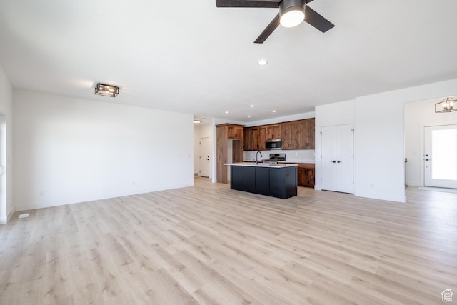 335 E Ventura Blvd, Stansbury Park, UT 84074 - unfurnished living room with light wood-style floors, recessed lighting, and a ceiling fan