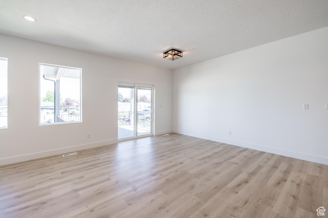 335 E Ventura Blvd, Stansbury Park, UT 84074 - spare room with light wood-style floors, a textured ceiling, and recessed lighting