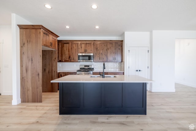 335 E Ventura Blvd, Stansbury Park, UT 84074 - kitchen with appliances with stainless steel finishes, light wood-style floors, brown cabinets, light countertops, and recessed lighting