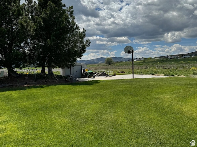 810 N 2300 W, Tremonton, UT 84337 - view of grassy yard with a mountain view, a view of rural / pastoral area, and a shed