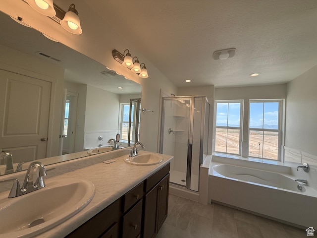 6927 W S Jordan Pkwy, South Jordan, UT 84009 - full bath with healthy amount of natural light, a garden tub, a stall shower, double vanity, and recessed lighting