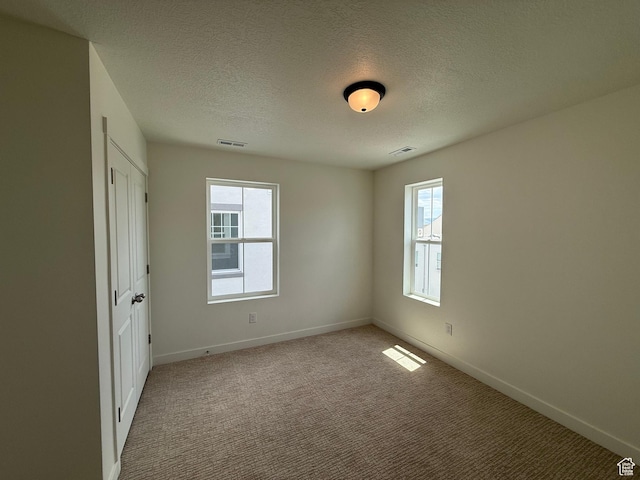 6927 W S Jordan Pkwy, South Jordan, UT 84009 - unfurnished bedroom with multiple windows, carpet flooring, and a textured ceiling