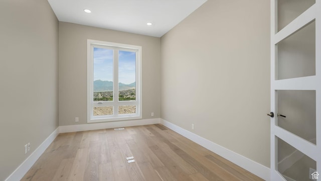 7233 W Summit Top Ln, Herriman, UT 84096 - spare room featuring light wood-style floors, recessed lighting, and a mountain view