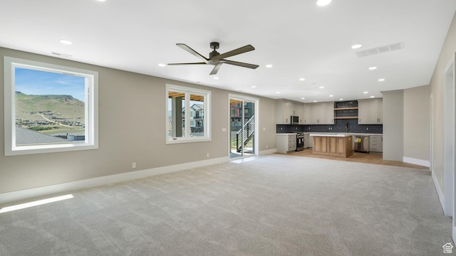7233 W Summit Top Ln, Herriman, UT 84096 - unfurnished living room with light carpet, recessed lighting, and a ceiling fan