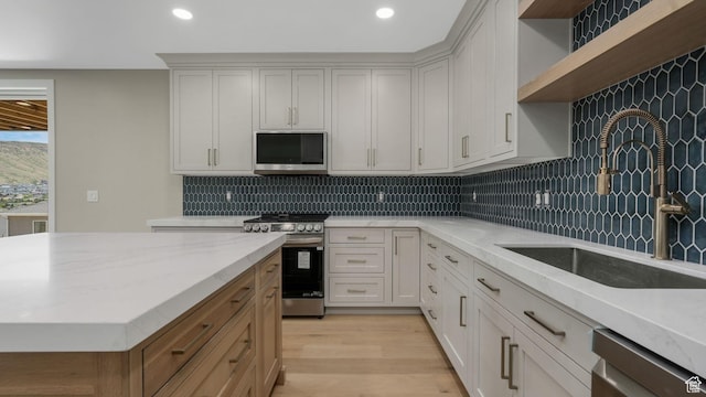 7233 W Summit Top Ln, Herriman, UT 84096 - kitchen with stainless steel appliances, open shelves, backsplash, recessed lighting, and light wood finished floors