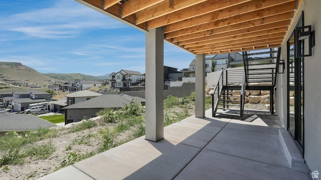 7233 W Summit Top Ln, Herriman, UT 84096 - view of patio featuring stairs, a residential view, and a mountain view