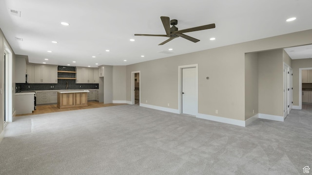 7233 W Summit Top Ln, Herriman, UT 84096 - unfurnished living room featuring light colored carpet, a ceiling fan, and recessed lighting