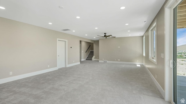 7233 W Summit Top Ln, Herriman, UT 84096 - spare room with stairway, light colored carpet, recessed lighting, and ceiling fan