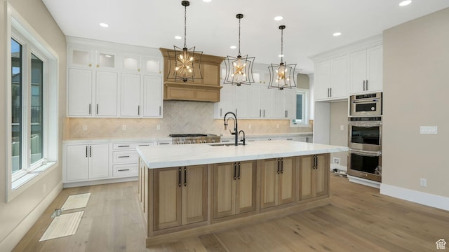 7233 W Summit Top Ln, Herriman, UT 84096 - kitchen with light wood-style floors, decorative backsplash, a kitchen island with sink, and recessed lighting