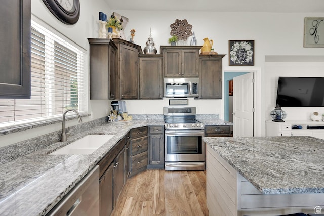 369 E Shelley Ln, Grantsville, UT 84029 - kitchen featuring stainless steel appliances, light wood-style floors, light stone countertops, and dark brown cabinetry