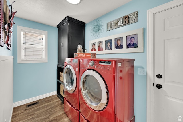 369 E Shelley Ln, Grantsville, UT 84029 - laundry room with washer and clothes dryer, cabinet space, and wood finished floors