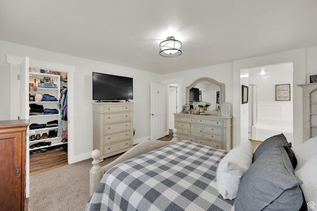 369 E Shelley Ln, Grantsville, UT 84029 - bedroom featuring a walk in closet, carpet flooring, a closet, and ensuite bathroom