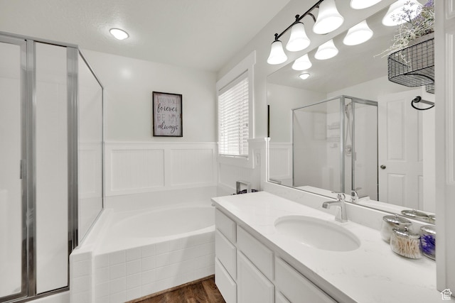 369 E Shelley Ln, Grantsville, UT 84029 - full bath with a stall shower, a bath, vanity, wood finished floors, and a wainscoted wall