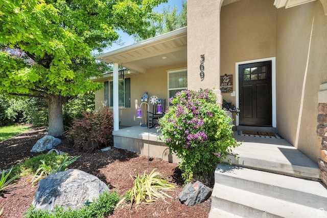 369 E Shelley Ln, Grantsville, UT 84029 - view of exterior entry featuring covered porch and stucco siding