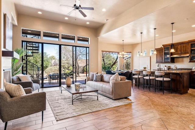 4962 W Boulder Vw, Hurricane, UT 84737 - living area featuring a ceiling fan, a chandelier, recessed lighting, light wood finished floors, and a towering ceiling