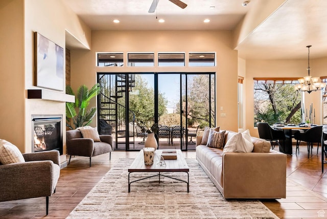 4962 W Boulder Vw, Hurricane, UT 84737 - living area featuring a chandelier, a ceiling fan, a glass covered fireplace, wood finished floors, and recessed lighting