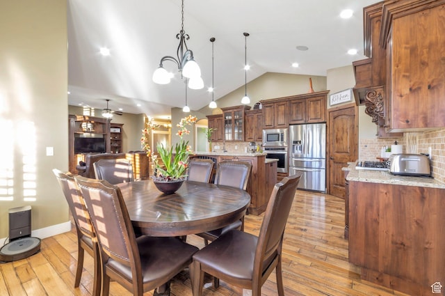 4948 W 4025 S, West Haven, UT 84401 - dining space featuring vaulted ceiling, light wood-style flooring, a chandelier, and ceiling fan