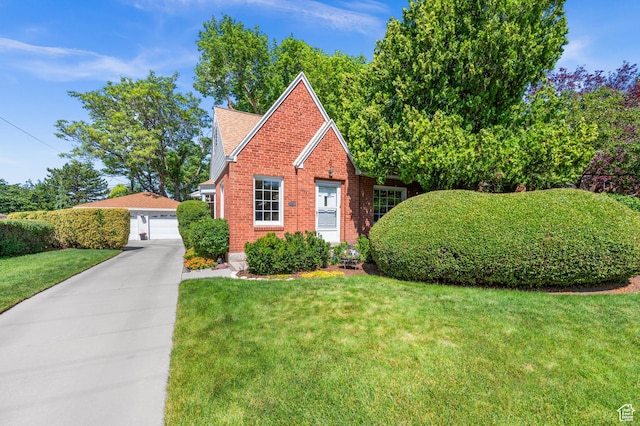 1632 S 1500 E, Salt Lake City, UT 84105 - view of front of house with a front yard, brick siding, a garage, and an outbuilding