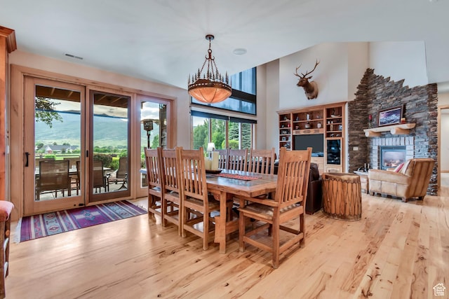 2984 Winterton Rd, Charleston, UT 84032 - dining area with wood finished floors and a stone fireplace