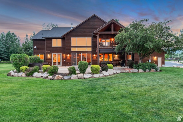 2984 Winterton Rd, Charleston, UT 84032 - back of property at dusk featuring a lawn, a patio, a garage, and a balcony
