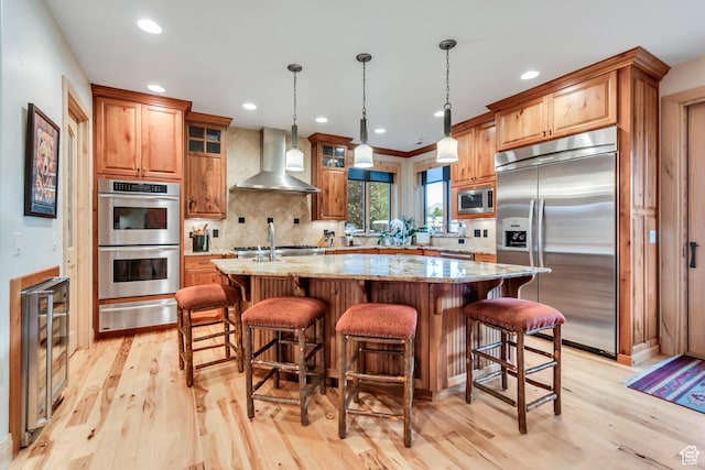 2984 Winterton Rd, Charleston, UT 84032 - kitchen with wall chimney exhaust hood, built in appliances, a warming drawer, beverage cooler, and light wood finished floors