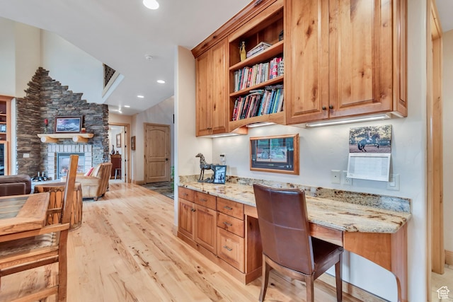 2984 Winterton Rd, Charleston, UT 84032 - kitchen with light stone counters, light wood-style flooring, open shelves, a fireplace, and recessed lighting