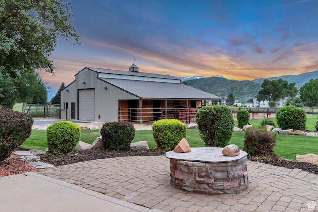 2984 Winterton Rd, Charleston, UT 84032 - back of property at dusk with a mountain view, a fire pit, an exterior structure, and an outbuilding