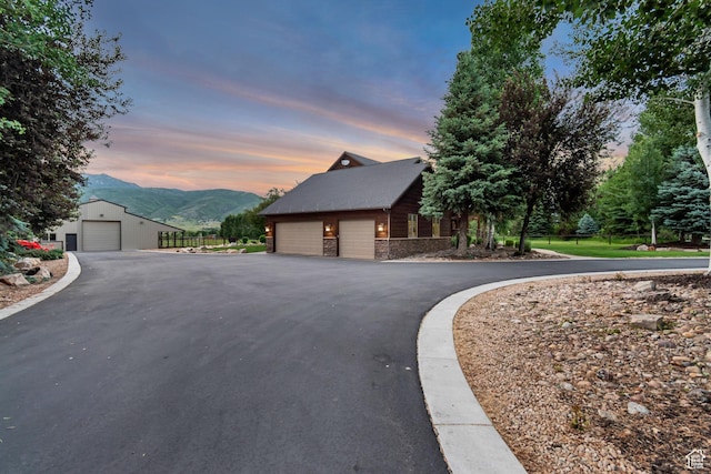 2984 Winterton Rd, Charleston, UT 84032 - view of home's exterior featuring a mountain view, an outdoor structure, stone siding, and a garage