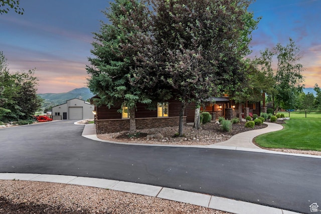 2984 Winterton Rd, Charleston, UT 84032 - view of front facade with stone siding, a garage, an outbuilding, a front lawn, and a mountain view