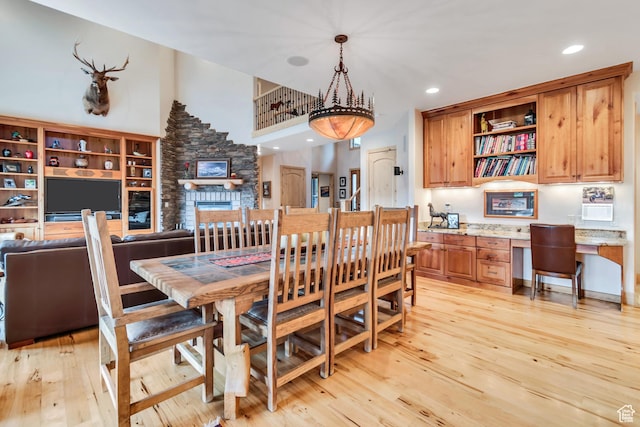 2984 Winterton Rd, Charleston, UT 84032 - dining room featuring built in study area, light wood-style flooring, recessed lighting, and a fireplace