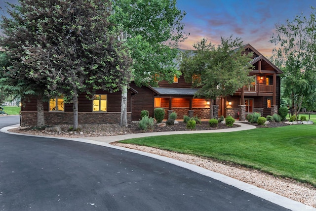 2984 Winterton Rd, Charleston, UT 84032 - view of front of house with stone siding, a front yard, a balcony, and asphalt driveway
