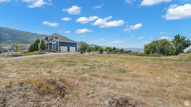 721 W Glovers Ln, Farmington, UT 84025 - view of yard featuring a mountain view, driveway, and a garage