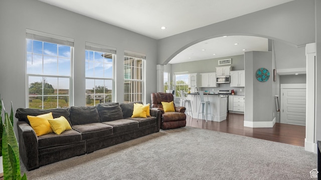721 W Glovers Ln, Farmington, UT 84025 - living area featuring dark colored carpet, arched walkways, recessed lighting, and dark wood-style floors