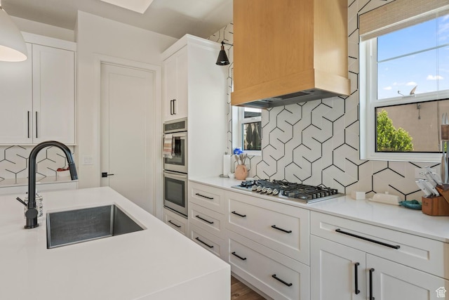 3214 S Red Sands Way, Hurricane, UT 84737 - kitchen featuring premium range hood, appliances with stainless steel finishes, backsplash, and white cabinetry