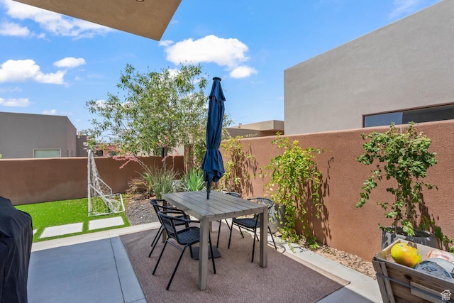 3214 S Red Sands Way, Hurricane, UT 84737 - fenced backyard featuring outdoor dining space and a patio