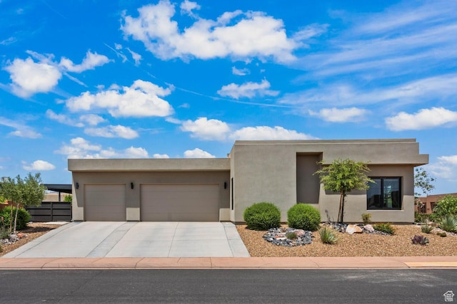 3214 S Red Sands Way, Hurricane, UT 84737 - pueblo-style house featuring a garage, driveway, and stucco siding