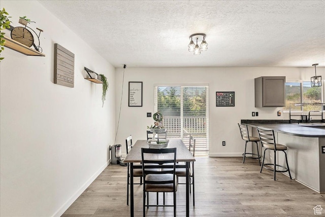 655 S 100 W, Santaquin, UT 84655 - dining space with plenty of natural light, a textured ceiling, wood finished floors, and a chandelier