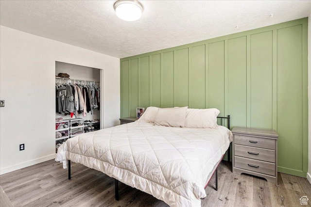 655 S 100 W, Santaquin, UT 84655 - bedroom with light wood-type flooring, a decorative wall, a closet, and a textured ceiling