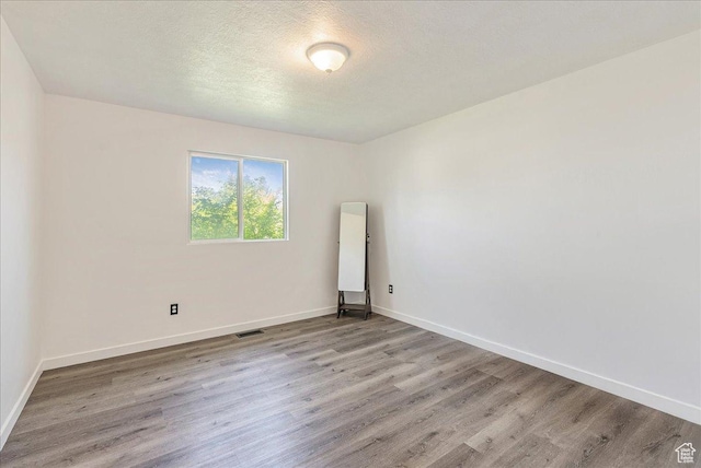 655 S 100 W, Santaquin, UT 84655 - spare room with light wood finished floors and a textured ceiling
