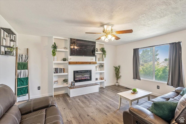 655 S 100 W, Santaquin, UT 84655 - living area with ceiling fan, wood finished floors, a textured ceiling, and a fireplace