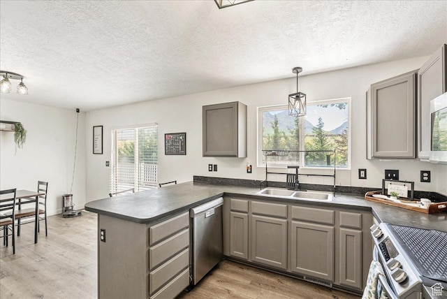 655 S 100 W, Santaquin, UT 84655 - kitchen featuring appliances with stainless steel finishes, gray cabinetry, dark countertops, light wood-style floors, and a textured ceiling