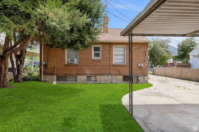 143 N 800 W, Provo, UT 84601 - view of property exterior featuring a chimney, brick siding, a patio, and a shingled roof
