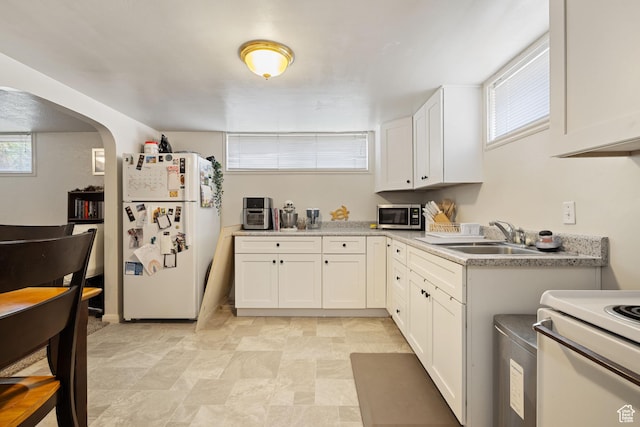 143 N 800 W, Provo, UT 84601 - kitchen featuring white appliances, white cabinetry, arched walkways, and light countertops