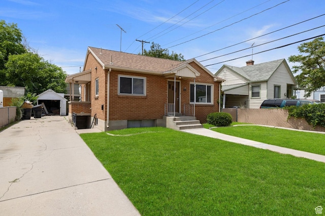 143 N 800 W, Provo, UT 84601 - view of front facade with brick siding, a detached garage, an outdoor structure, and a shingled roof