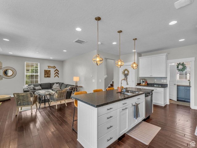 4966 W Willamette Way S, South Jordan, UT 84095 - kitchen with stainless steel dishwasher, a kitchen breakfast bar, dark wood-style flooring, open floor plan, and white cabinets
